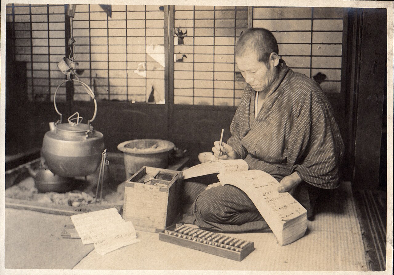 帳簿に筆で記入する人(1914年)